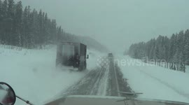 Driving a big rig on snow covered road, Trans-Canada HWY 1 in British Columbia, Canada, North America.