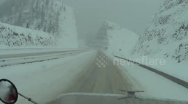 Driving a big rig down a steep, snow covered grade in British Columbia, Canada