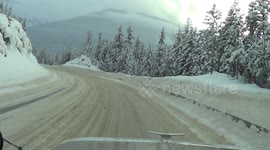 Driving a big rig down a steep, snow covered hill in British Columbia, Canada.