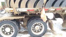 Hauling giant mining tyres in winter with a semi truck trailer in North America