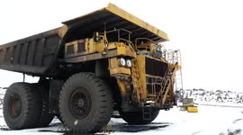 Delivering giant mining tyres in winter with a semi truck trailer in North America