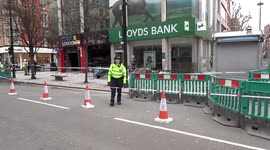 Police lady at the fire site of Colour London souvenir store in Oxford Street - London