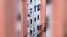 Neighbours save toddler hanging from fourth-floor window in China