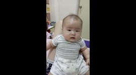 Funny baby adorably falling down on bed