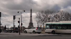 Traffic in Paris and view of Eiffel tower in Paris
