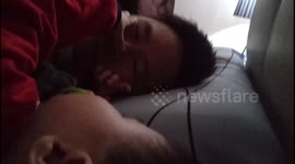 Toddler caught on camera disturbing his dad sleeping