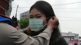 Indonesian police distribute free masks to residents to prevent spread of coronavirus