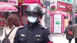 Chinese police wear helmets fitted with infrared device to detect pedestrians' temperature amid coronavirus outbreak