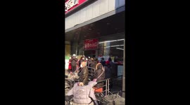 Huge queues outside Beijing supermarket as face masks go back on sale