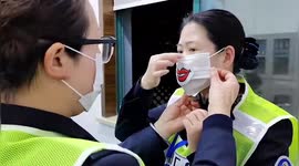 Toll gate staff on Chinese highway draw smiles on their face masks to appear friendly