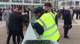 Racegoers using hand gel sanitisers at Cheltenham Festival