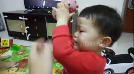 Toddler stops crying instantly when given a piggy bank