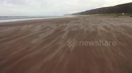 Dramatic Blowing Sand On Beach In Strong Winds - Drone View