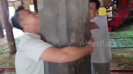 By hugging this pole at a mosque, these worshippers in Indonesia believe their dreams will come true