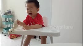 Smart toddler stops crying instantly when he is given money by his dad