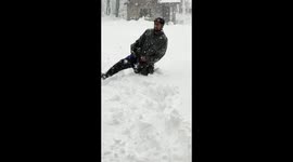 Indian residents struggle to walk as almost four foot of snow falls in Kashmir