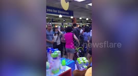Shoppers form long queues in supermarket amid coronavirus lockdown in Manila
