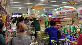 Shoppers queue in supermarket during panic-buying spree in Bangkok