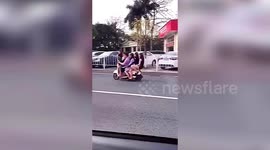 Chinese man rides scooter with five women on it