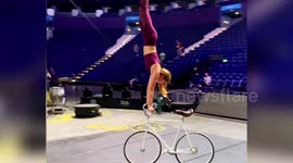 This incredibly talented cyclist can ride her bike while doing a handstand