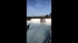 Boy scores between the legs spinorama hockey goal on his backyard rink during self-isolation