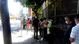 Venezuelans in face masks seen queuing to buy food during COVID-19 lockdown