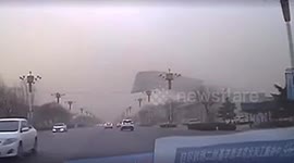 Powerful winds blow off building roof, damaging several vehicles in north China
