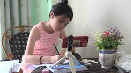 A school girl in Thailand studying online on her birthday.