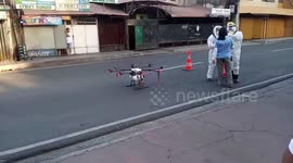 Health workers fly DRONES to spray disinfectant in streets in the Philippines