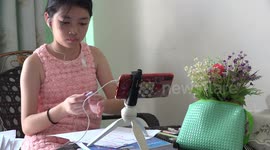Studying online at home during the virus pandemic in Thailand.