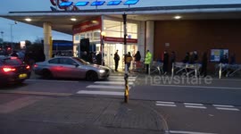 Shoppers queue outside Tesco in London at 6 a.m.
