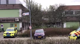 Ambulance driving up at hospital showing coronavirus tents