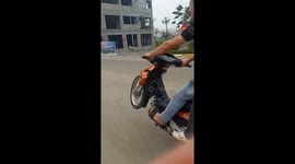 Two men riding the motorcycle by one wheel with high speed on the road