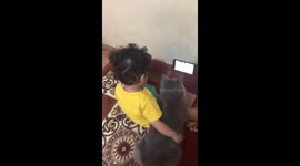 a small child engrossed in watching videos with cats