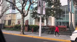 Coronavirus: Shanghai shoppers return to luxury stores wearing face masks