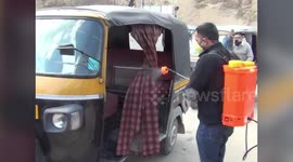 Auto-rickshaws disinfected to stop spread of coronavirus outbreak in northern India