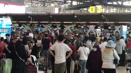 Chaos at Bangkok airport as tourists scramble to return home amid soaring coronavirus cases