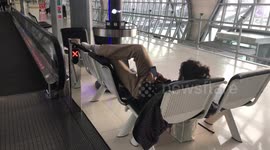 Backpacker ignores coronavirus hygiene and puts his stinking, DIRTY feet on chairs in airport departure lounge
