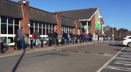 British shoppers in Norfolk calmly queuing outside supermarket