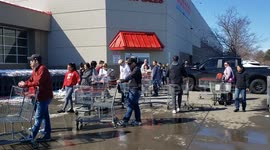 Line of people waiting to get in to Costco, the traffic has been slowed to avoid large gatherings inside the store