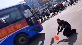 Chinese man bows down to thank coronavirus medical workers who saved 11 infected family members