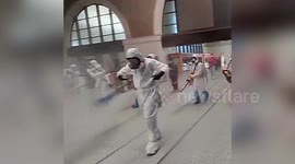 Humanitarian workers spray Wuhan train station with disinfectant after months of lockdown