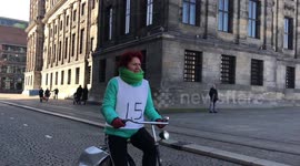Keep your distance! Amsterdam cyclist warns people to stay 1.5m away with message on her vest
