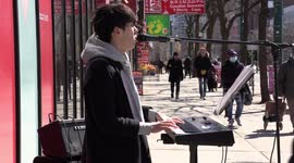 Busker from South Korea performs in Toronto to cheer up residents as they shop for supplies during COVID-19 pandemic as all non-essential business now ordered to close