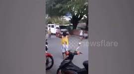 Filipino pensioners reminisce in the street with childhood game