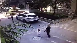 Man and girl narrowly avoid being crushed by glass window that fell from residential building in China