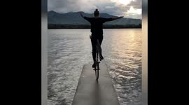 Witness this woman perform unbelievable bike trick on narrow boardwalk