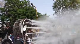 Indian officials use high-pressure water jets attached to fan to spray disinfectant