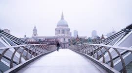 Pedestrians cross over St Pauls footbridge during Coronavirus pandemic