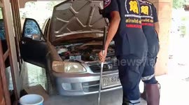 Thai driver finds king cobra coiled up in his car engine